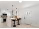 Beautiful kitchen with modern appliances, breakfast bar, white cabinets, and black hardware and decor at 5255 Seminole Ave, Winter Park, FL 32792