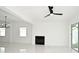 Bright living room featuring tile floors, fireplace, modern ceiling fan, and sliding glass doors at 5255 Seminole Ave, Winter Park, FL 32792