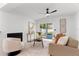 Bright living room with fireplace, neutral furniture, sliding glass doors, and modern decor at 5255 Seminole Ave, Winter Park, FL 32792