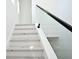 Modern staircase featuring a glass railing and white wood treads and risers at 5255 Seminole Ave, Winter Park, FL 32792