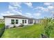 Image of the backyard, featuring a well-manicured lawn, landscaping, and a screened-in patio at 538 Stowers Dr, New Smyrna Beach, FL 32168