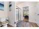 Bathroom featuring a glass-enclosed shower, toilet, and doorway leading to the bedroom at 538 Stowers Dr, New Smyrna Beach, FL 32168