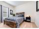 Bedroom with a wooden bed frame, cozy blue bedding, and a bright window at 538 Stowers Dr, New Smyrna Beach, FL 32168