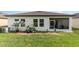 House back view with screened porch and yard at 538 Stowers Dr, New Smyrna Beach, FL 32168