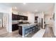 Modern kitchen featuring granite countertops, dark wood cabinets, and a stainless steel refrigerator and appliances at 538 Stowers Dr, New Smyrna Beach, FL 32168