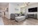 Comfortable living room with a gray sectional, modern furniture, and a ceiling fan for added comfort at 538 Stowers Dr, New Smyrna Beach, FL 32168