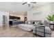 Open-concept living space with a comfortable gray sectional couch adjacent to the kitchen with breakfast bar at 538 Stowers Dr, New Smyrna Beach, FL 32168