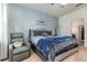 Comfortable main bedroom featuring a cozy chair and stylish decor at 538 Stowers Dr, New Smyrna Beach, FL 32168