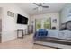 Main bedroom showcasing a large TV, desk, and window with natural light at 538 Stowers Dr, New Smyrna Beach, FL 32168