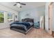 Main bedroom with a plush bed, blue accent wall, and a bright window at 538 Stowers Dr, New Smyrna Beach, FL 32168