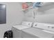 Well-equipped laundry room with a washer, dryer, and ample storage space, offering convenience and functionality at 8443 Crystal Cove Loop, Kissimmee, FL 34747