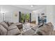 Comfortable living room with a large sectional sofa, sliding glass doors to the outside, and modern entertainment center at 8443 Crystal Cove Loop, Kissimmee, FL 34747