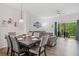 Open-concept living and dining area featuring modern decor and sliding glass doors to the outside at 8443 Crystal Cove Loop, Kissimmee, FL 34747