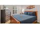 Cozy main bedroom features a queen-sized bed, dresser, and natural light with a peaceful and inviting atmosphere at 8443 Crystal Cove Loop, Kissimmee, FL 34747