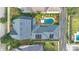 An aerial view of the home showcasing its backyard pool, lush landscaping, and roof with solar panels at 1131 Fern Ave, Orlando, FL 32814