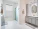 Bathroom featuring double vanity, large mirror, and glass shower at 1131 Fern Ave, Orlando, FL 32814