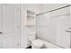 Bright bathroom showcasing toilet, shower with glass doors, and white shelving at 1131 Fern Ave, Orlando, FL 32814