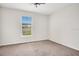 Neutral bedroom with gray carpet, single window, and ceiling fan at 1131 Fern Ave, Orlando, FL 32814