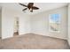 Bedroom with neutral carpet, a door leading to bathroom, and a window for natural light at 1131 Fern Ave, Orlando, FL 32814