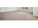 Spacious bedroom with neutral carpet, baseboard trim and multiple windows that let in natural light at 1131 Fern Ave, Orlando, FL 32814
