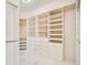 Organized walk-in closet with white shelving, drawers, and multiple hanging rods for storage at 1131 Fern Ave, Orlando, FL 32814