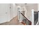 Bright hallway featuring modern staircase with iron railings and carpeted floors at 1131 Fern Ave, Orlando, FL 32814