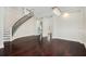 Bright living room featuring a curved staircase, wine cellar, hardwood floors, and stylish chandelier at 1131 Fern Ave, Orlando, FL 32814