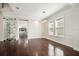Bright living room featuring hardwood floors, modern lighting, and large windows for natural light at 1131 Fern Ave, Orlando, FL 32814