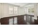 Bright living room featuring hardwood floors, modern lighting, and large windows for natural light at 1131 Fern Ave, Orlando, FL 32814