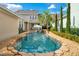 Inviting backyard pool area with rock surround, tropical landscaping, and patio seating, perfect for relaxation at 1131 Fern Ave, Orlando, FL 32814