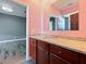 Bathroom with wood vanity and granite countertop at 1424 Richmond Grand Ave, Orlando, FL 32820