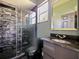 Modern bathroom with glass shower, stone tile, and granite vanity at 1424 Richmond Grand Ave, Orlando, FL 32820