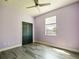 Spacious bedroom with light purple walls and hardwood floors at 1424 Richmond Grand Ave, Orlando, FL 32820