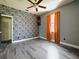 Bright bedroom with floral wallpaper and hardwood floors at 1424 Richmond Grand Ave, Orlando, FL 32820