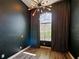 Dark-walled bedroom with large window and patterned curtains at 1424 Richmond Grand Ave, Orlando, FL 32820