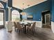 Dining room with hardwood floors, white wainscoting and blue walls at 1424 Richmond Grand Ave, Orlando, FL 32820