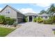 Two-story house with gray siding, paver driveway and landscaping at 1424 Richmond Grand Ave, Orlando, FL 32820