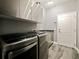Laundry room with stainless steel appliances and granite countertop at 1424 Richmond Grand Ave, Orlando, FL 32820