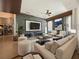 Elegant living room with large TV, comfortable seating, and stone wall at 1424 Richmond Grand Ave, Orlando, FL 32820