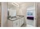 Bathroom with double vanity, granite countertop, and view of bedroom at 1656 Aspen Ave, Davenport, FL 33837
