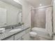Clean bathroom featuring vanity with granite countertop and shower-tub combo at 1656 Aspen Ave, Davenport, FL 33837