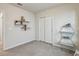 Bright bedroom with neutral carpet, closet, floating shelves, and stylish accents at 1656 Aspen Ave, Davenport, FL 33837