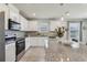 Well-lit kitchen with granite counters, tile backsplash, and modern appliances at 1656 Aspen Ave, Davenport, FL 33837