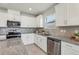 Modern kitchen with white cabinets and granite countertops at 1656 Aspen Ave, Davenport, FL 33837