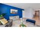 Living room with blue accent wall, gray sofa, and TV at 1656 Aspen Ave, Davenport, FL 33837