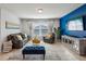 Cozy living room featuring stylish furniture, a blue accent wall and ample lighting at 1656 Aspen Ave, Davenport, FL 33837