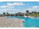 Inviting community pool with palm trees and a covered area for gatherings at 1656 Aspen Ave, Davenport, FL 33837