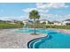Community pool featuring a splash fountain, palm trees, and ample seating at 1656 Aspen Ave, Davenport, FL 33837