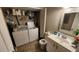 Bathroom with white vanity, toilet, and laundry area at 1724 Silver Creek Ct # 105, Orlando, FL 32807