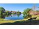 Community lake with a bench and tranquil view at 1724 Silver Creek Ct # 105, Orlando, FL 32807